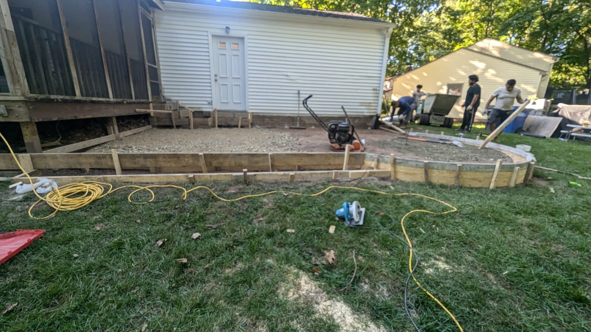 Curved wood forms staked out for a circular concrete patio, full view